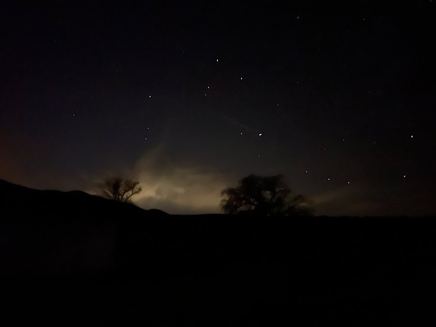 Night sky with a light-pollution glow dome on the horizon